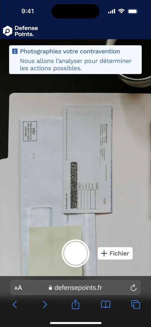 Phone screen: the camera view, with the instruction to photograph the notice and a button to attach a file instead.